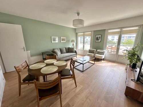 un salon avec une table et un canapé dans l'établissement SEA VIEW terrace and garage in Berck-Plage, à Berck-sur-Mer