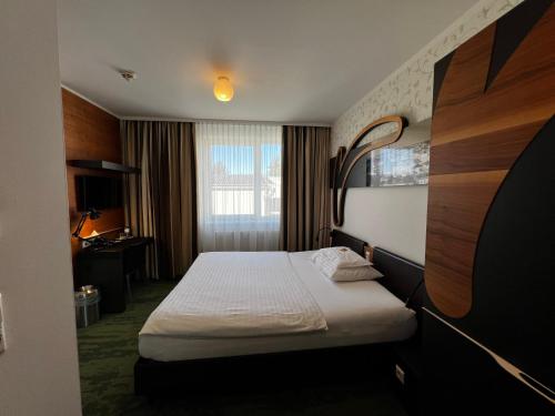 Postel nebo postele na pokoji v ubytování H+ Hotel Ried