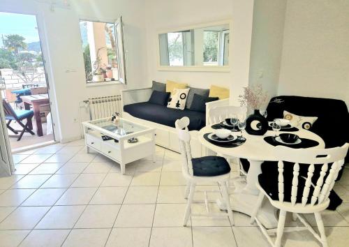a living room with a table and a couch at Villa Mali Ston (3588) in Mali Ston