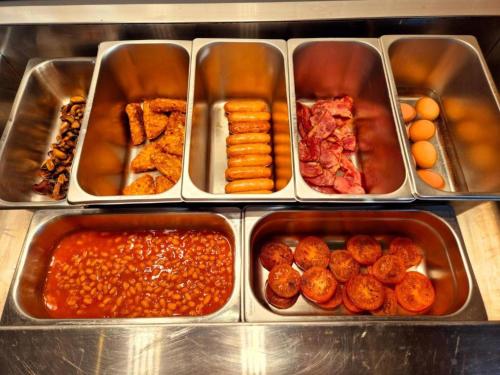 a bunch of trays filled with different types of food at Boston Supreme Hotel in Boston