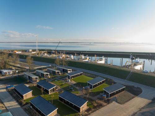 an aerial view of a harbor with buildings and the water at Oysterduinen - Resort Yerseke in Yerseke