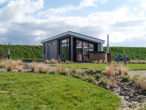 a tiny house in the middle of a garden at Oysterduinen - Resort Yerseke in Yerseke