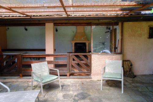 two chairs sitting on the porch of a house at Villa del Sole - Lake Como Garden in Cernobbio