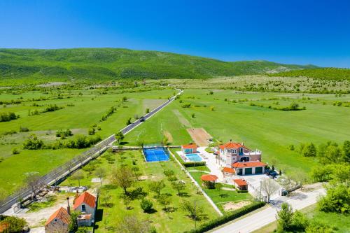 an aerial view of a house in a field at 5-Bed Villa with Pool, Jacuzzi & Padel Court in Drniš