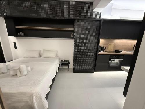 a bedroom with a large bed and a kitchen at Old Town Flat in Patra