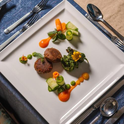 a white plate with food in the shape of a heart at The Oberoi Beach Resort, Sahl Hasheesh in Hurghada