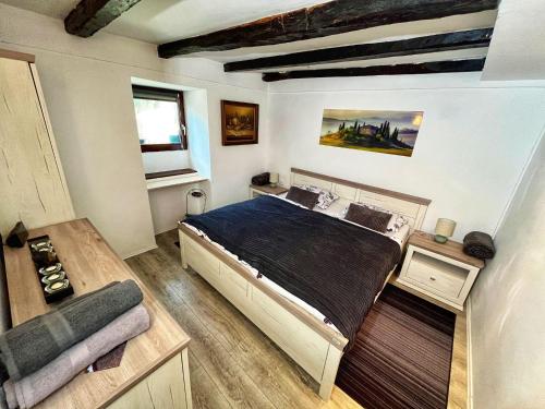 a bedroom with a large bed and a window at Apartman Bela in Matulji
