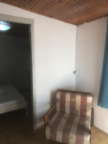 a room with a bed and a couch in a room at Barreira Beachfront Room 5 in Kalamata