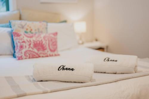 a white bed with two pillows on it at Elevated Ocean View Oasis - 3BR 2 Bath Parking in Christchurch