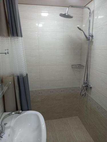 a bathroom with a shower and a sink at Qozi Hotel in Samarkand