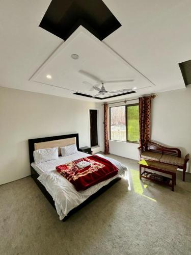 a bedroom with a large bed and a piano at EYE VIEW GUEST HOUSE skardu in Skardu