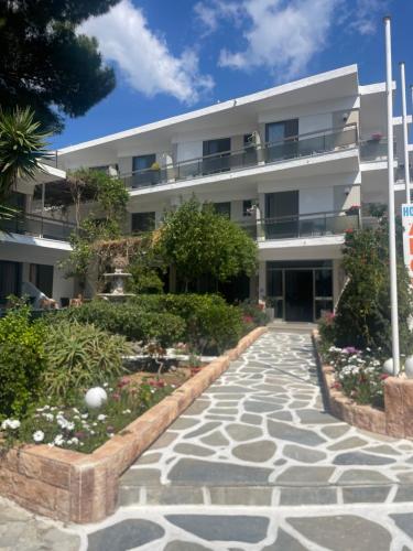 a building with a walkway in front of it at Angela Hotel in Agia Marina Aegina
