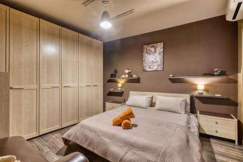 a bedroom with a bed with a teddy bear on it at Central + Bright Apartment in St. Julians in St. Julianʼs