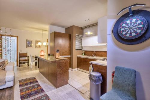 a kitchen with a dart board on the wall at Central + Bright Apartment in St. Julians in St. Julianʼs
