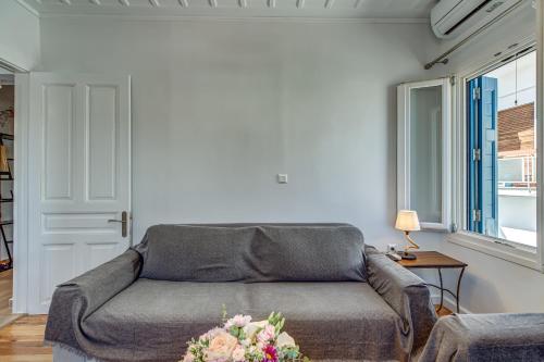 a living room with a couch and a window at Andy Port House with Seaview by Goutos Properties in Ermioni
