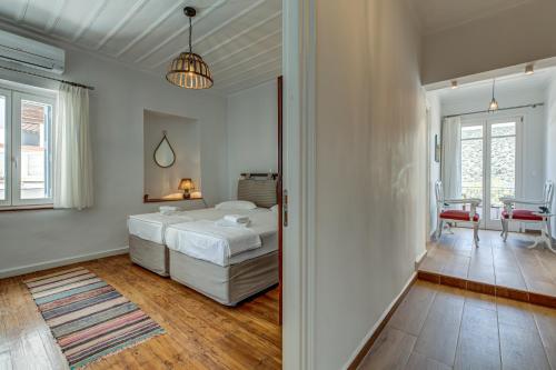 a bedroom with a bed and a living room at Andy Port House with Seaview by Goutos Properties in Ermioni