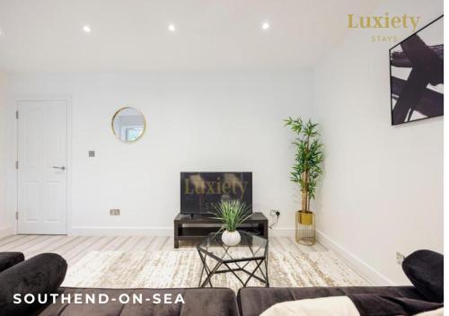 a living room with white walls and a couch at Stylish & Modern 1BR City Centre Nr the beach, High St & Adventure Island by Luxiety Stays in Southend-on-Sea