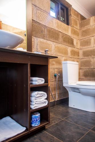 a bathroom with a sink and a toilet at Fun Retreat Resort, Hotel and Ayurveda Spa in Arusha