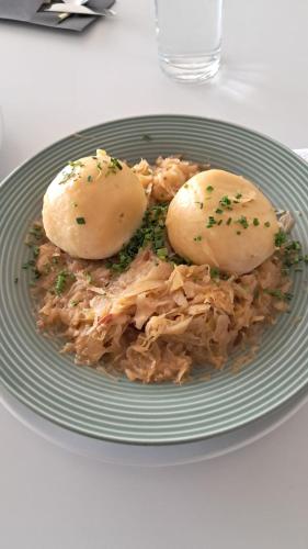 a plate of food with two rolls on top at Hotel Telegraph in Oberwart