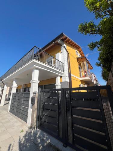 a house with a black gate in front of it at Soulmondo Beach Rooms in Campomarino