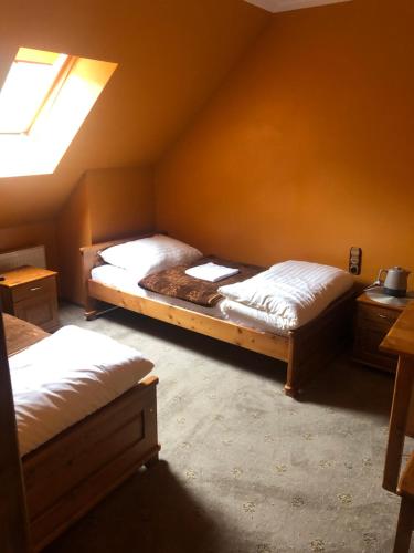 a bedroom with two beds in a room at Zajazd Pasterniki in Krościenko