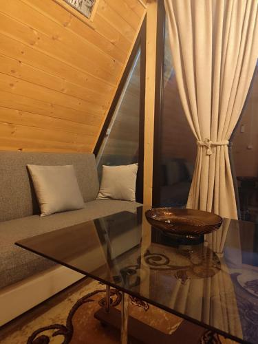 a living room with a couch and a glass table at Cottege Merisi's Side in Merisi