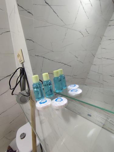 a group of four bottles on a counter in a bathroom at Cottege Merisi's Side in Merisi