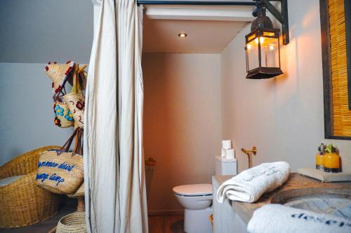 a bathroom with a tub and a toilet and a sink at Sanmao Desert Luxury Camp in Merzouga