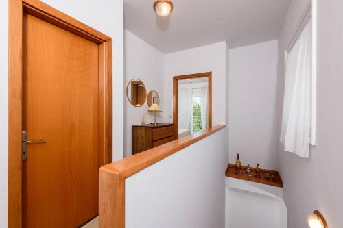 a bathroom with a toilet and a sink and a mirror at Agapi Deluxe Villa in Skala Rachoniou