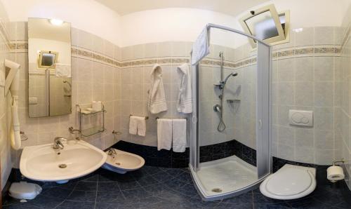 a bathroom with a sink and a shower and a toilet at Villaggio San Pablo in Vieste