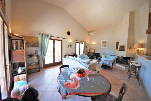 un salon avec une table et un canapé dans l'établissement Maison Famiglia Sérénité et nature, à Porto-Vecchio