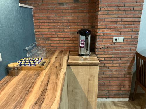 a coffee machine sitting on a counter next to a brick wall at Hotel 717 Kazbegi in Stepantsminda