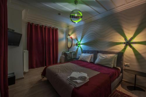 a bedroom with a bed with towels on it at Amfitriti Palazzo in Nafplio