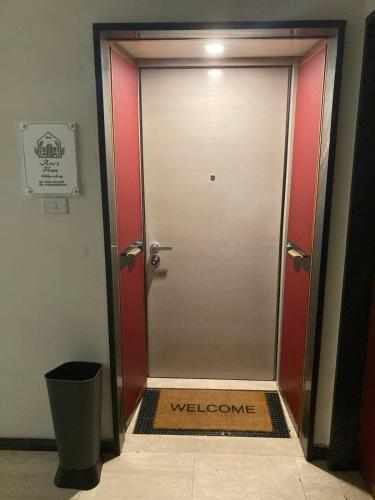 a door with a welcome sign in front of it at Aro's House in Cremona