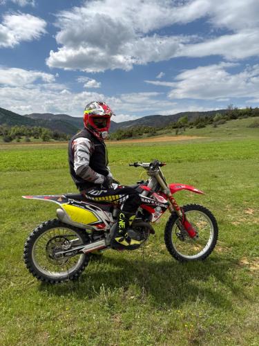 a person sitting on a dirt bike in a field at Voyage House in the countryside Polen in Korçë