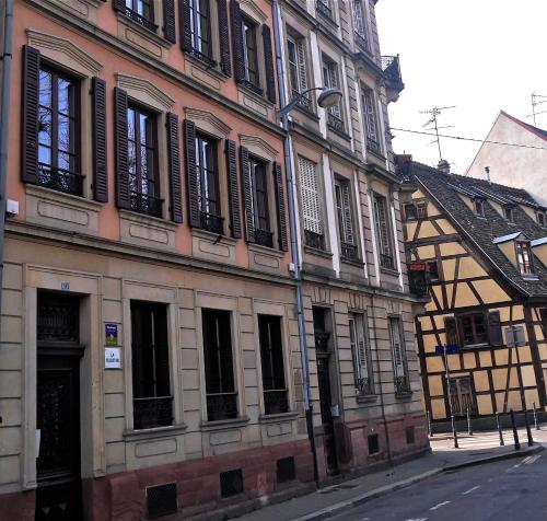a large building with a clock on the side of it at Chambre d'hôtes La Célestine in Strasbourg