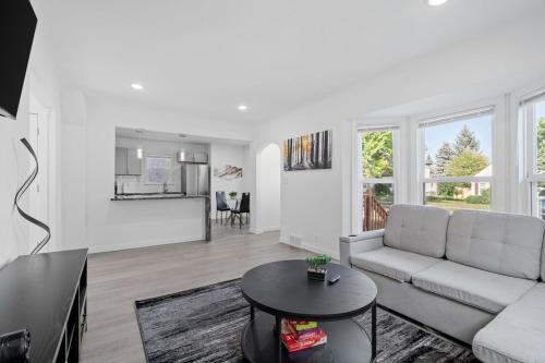a living room with a couch and a table at Movie Game Room & Fire Pit Luxury Spacious Home in Minneapolis