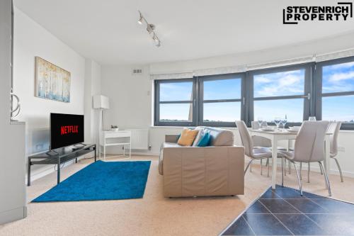 a living room with a couch and a table at Central Reading, 2 Bedroom Apartment, Secure Parking, Skyline View in Reading