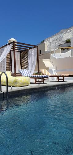 two beds on the side of a swimming pool at Kalitsi Canaves in Vóthon