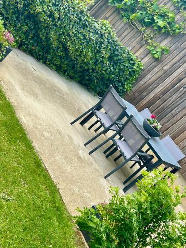 two chairs and a table on a patio at Ô Baguenaudes in Jalhay