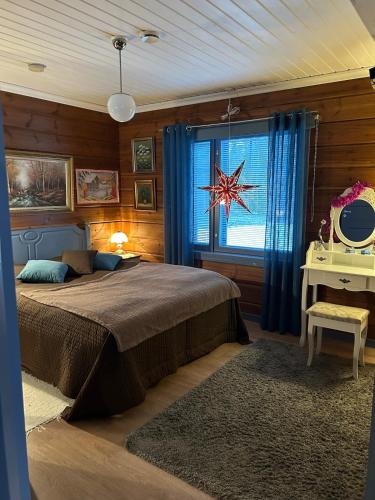 a bedroom with a bed and a window with a star decoration at Traditional Lapland 2BR House with Private sauna in Nuupas