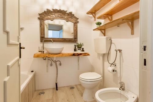 a bathroom with a toilet and a sink and a mirror at Cascais Ocean View by Homing in Cascais