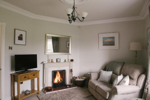 a living room with a couch and a fireplace at Shirley's House in Omagh