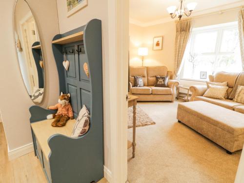 a living room with a teddy bear sitting on a door at Shirley's House in Omagh