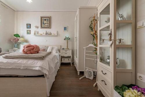 a bedroom with a bed with a pink pillow on it at Casa Rustica Ivano in Biograd na Moru