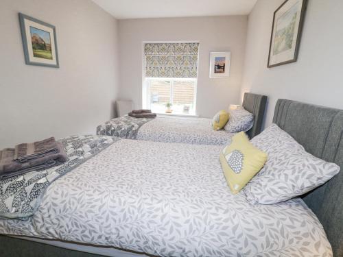 a bedroom with two beds and a window at Shirley's House in Omagh