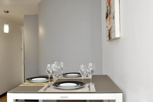 a table with wine glasses and plates on it at T2 LUXURY - Close to beaches in Le Gosier