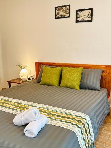 a bedroom with a bed with towels on it at Tiami Eden Villa - Nghỉ Dưỡng Sân Vườn Ven Biển in Vung Tau
