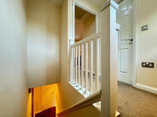 a staircase in a house with a stair case at Charming 1-Bedroom Retreat in the Heart of Warwick in Warwick