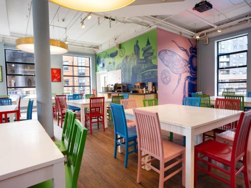 a dining room with tables and colorful chairs at YHA Manchester in Manchester